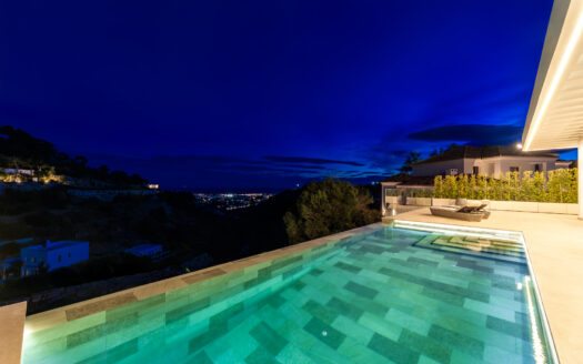 Is an exclusive new development located in the heart of Madroñal, Benahavís.This exceptional project comprises two identical contemporary villas, both offering breathtaking panoramic sea views and set within a prestigious gated community with 24-hour security.This villa spans three levels and is designed to provide the ultimate in luxury living.The lower floor features a private spa with the latest micro-cementation technology, including a heated indoor pool, Finnish sauna, and Turkish bath.Additionally, residents will enjoy a fully equipped gym, a games room with a pool table, a bar, and a spacious wine cellar.The architectural concept revolves around two elegant glass cubes, which create an internal courtyard where a beautiful olive tree takes center stage an ideal setting for relaxing or enjoying shisha. Floor-to-ceiling windows flood the interiors with natural light while incorporating sun protection for a comfortable atmosphere year-round.The outdoor area offers an expansive terrace with panoramic sea views and an infinity pool made from Indonesian stone, renowned for its water-purifying properties. Sunbeds, a large dining table, and a stylish chill-out zone complete this perfect Mediterranean retreat.The master suite is thoughtfully designed with two en-suite bathrooms and two separate dressing areas, maximizing both comfort and privacy. A staff room and a dedicated laundry area further enhance functionality.Technology and entertainment are state-of-the-art, with the latest OLED TV featuring Acoustic Surface Audio and a BOSE sound system integrated with artificial intelligence.Each villa also includes a private garage with space for four vehicles. In the near future, a new road will connect Madroñal directly with Real de la Quinta and Nueva Andalucía, improving access and convenience.Offers an extraordinary living experience where striking modern design, top-tier amenities, and stunning sea views come together in perfect harmony.